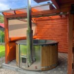 Fiberglass hot tub with integrated wood fired heater