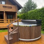 XL fiberglass hot tub with integrated wood fired heater